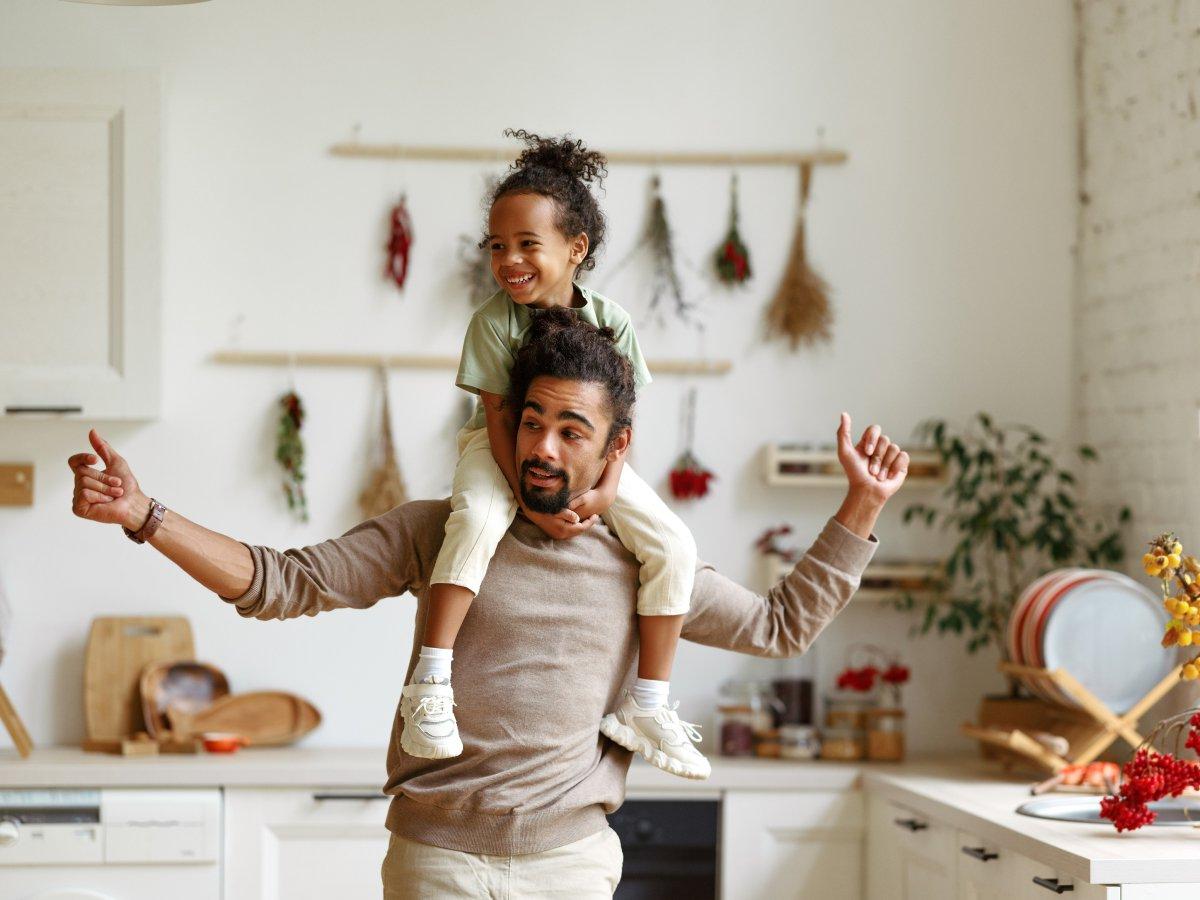 Dad giving piggyback ride to child